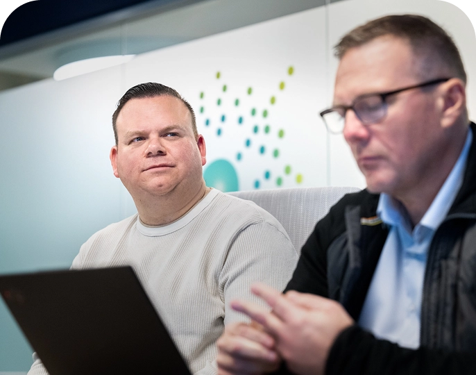 Two Mariana Oncology employees sitting in a conference room during a meeting