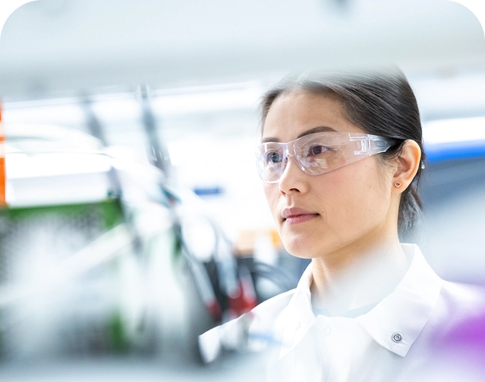 Closeup of Mariana Oncology scientist wearing eye protection working in the lab